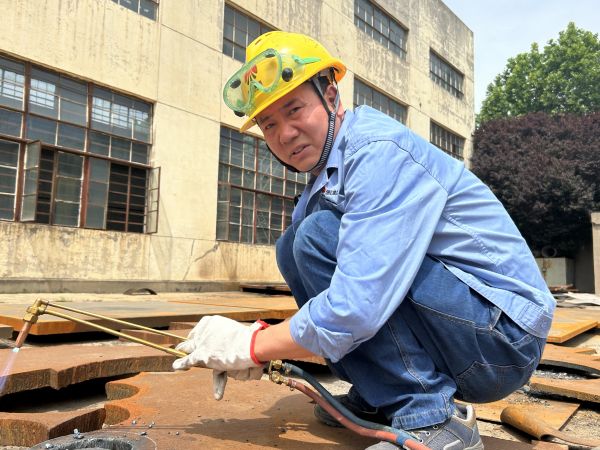 第三突擊隊(duì)隊(duì)長朱鎖榮在602廠房下料.jpg